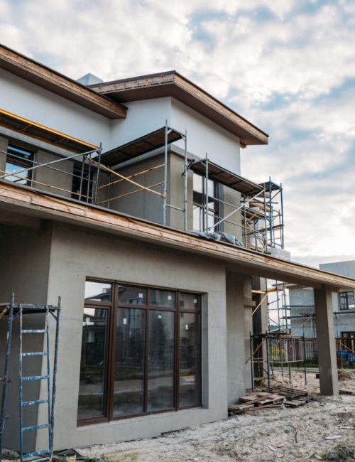 close-up shot of contemporary building construction with scaffolding under cloudy sky
