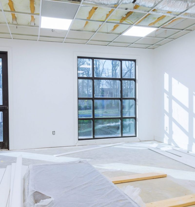 Making renovation of hung of suspended ceilings lights high in a bright modern office