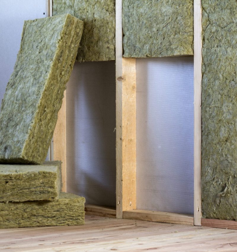 Wooden frame for future walls with drywall plates insulated with rock wool and fiberglass insulation staff for cold barrier. Comfortable warm home, economy, construction and renovation concept.